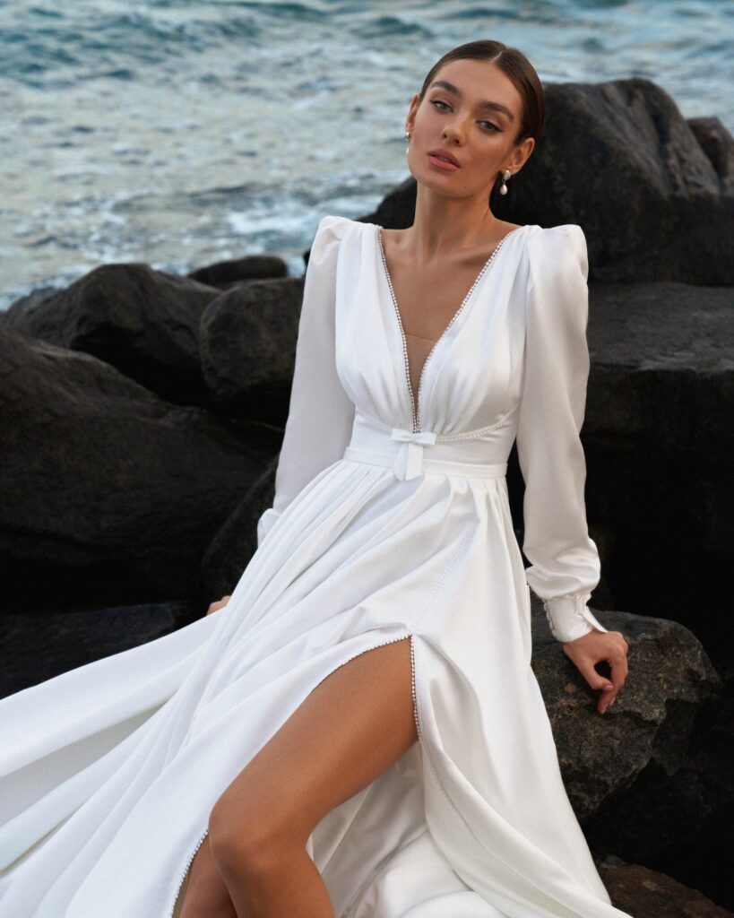 Fabric is Crepe, silhouette is A-line, neckline is V-neck, sleeve style is Long sleeves, train is Chapel train, waistline is Natural, embellishment is None, back is , color is White, style is Traditional,