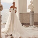 olya mak charmy draped off shoulder mermaid long train crepe wedding dress 01