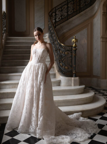 Fabric is Lace & Tulle, silhouette is Ball Gown, neckline is Sweetheart, sleeve style is Strapless, train is Chapel, waistline is Basque, embellishment is Floral Lace Appliqué, back is Corset Back, color is Champagne/Ivory/Nude, style is Romantic Couture, Sheer bodice, pockets