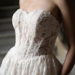 Fabric is Lace & Tulle, silhouette is Ball Gown, neckline is Sweetheart, sleeve style is Strapless, train is Chapel, waistline is Basque, embellishment is Floral Lace Appliqué, back is Corset Back, color is Champagne/Ivory/Nude, style is Romantic Couture, Sheer bodice, pockets