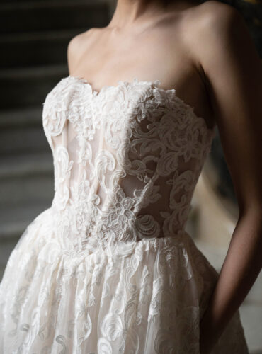 Fabric is Lace & Tulle, silhouette is Ball Gown, neckline is Sweetheart, sleeve style is Strapless, train is Chapel, waistline is Basque, embellishment is Floral Lace Appliqué, back is Corset Back, color is Champagne/Ivory/Nude, style is Romantic Couture, Sheer bodice, pockets