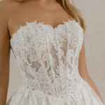 Fabric is Lace & Tulle, silhouette is Ball Gown, neckline is Sweetheart, sleeve style is Strapless, train is Chapel, waistline is Basque, embellishment is Floral Lace Appliqué, back is Corset Back, color is Champagne/Ivory/Nude, style is Romantic Couture, Sheer bodice, pockets