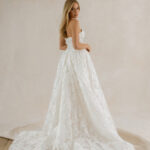 Fabric is Lace & Tulle, silhouette is Ball Gown, neckline is Sweetheart, sleeve style is Strapless, train is Chapel, waistline is Basque, embellishment is Floral Lace Appliqué, back is Corset Back, color is Champagne/Ivory/Nude, style is Romantic Couture, Sheer bodice, pockets