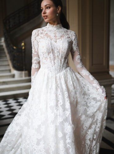 Fabric is Sheet lace, silhouette is Fitted jacket overlay, neckline is High neck, sleeve style is Long sleeves, train is None (overlay jacket only), waistline is Natural, fitted to gown, embellishment is Intricate lace appliqué, back is Sheer illusion with button closure, color is Ivory/Nude, style is Regal, Vintage-inspired, Detachable, versatile for ceremony-to-reception transformation