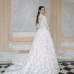 Fabric is Sheet lace, silhouette is Fitted jacket overlay, neckline is High neck, sleeve style is Long sleeves, train is None (overlay jacket only), waistline is Natural, fitted to gown, embellishment is Intricate lace appliqué, back is Sheer illusion with button closure, color is Ivory/Nude, style is Regal, Vintage-inspired, Detachable, versatile for ceremony-to-reception transformation
