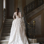 Fabric is Sheet lace, silhouette is Fitted jacket overlay, neckline is High neck, sleeve style is Long sleeves, train is None (overlay jacket only), waistline is Natural, fitted to gown, embellishment is Intricate lace appliqué, back is Sheer illusion with button closure, color is Ivory/Nude, style is Regal, Vintage-inspired, Detachable, versatile for ceremony-to-reception transformation