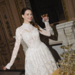 Fabric is Sheet lace, silhouette is Fitted jacket overlay, neckline is High neck, sleeve style is Long sleeves, train is None (overlay jacket only), waistline is Natural, fitted to gown, embellishment is Intricate lace appliqué, back is Sheer illusion with button closure, color is Ivory/Nude, style is Regal, Vintage-inspired, Detachable, versatile for ceremony-to-reception transformation