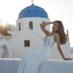 Fabric is Crepe & Lace, silhouette is Sheath, neckline is Illusion Plunge, sleeve style is Spaghetti Straps, train is Chapel with Lace Appliqué, waistline is Natural, embellishment is Floral Lace Appliqué, back is Illusion Low Back, color is Ivory/Nude, style is Modern Romantic, Sheer bodice, Button-back detailing, Lightweight crepe skirt
