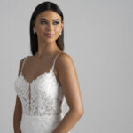 Fabric is Crepe & Lace, silhouette is Sheath, neckline is Illusion Plunge, sleeve style is Spaghetti Straps, train is Chapel with Lace Appliqué, waistline is Natural, embellishment is Floral Lace Appliqué, back is Illusion Low Back, color is Ivory/Nude, style is Modern Romantic, Sheer bodice, Button-back detailing, Lightweight crepe skirt