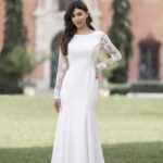 Fabric is Crepe & Lace, silhouette is Sheath, neckline is High Neckline, sleeve style is Long Lace, train is Sweep Train, waistline is Natural, embellishment is Lace Appliqué, back is Low Scoop, color is Ivory/Nude, style is Minimalist Elegance, Buttons down the back