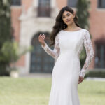 Fabric is Crepe & Lace, silhouette is Sheath, neckline is High Neckline, sleeve style is Long Lace, train is Sweep Train, waistline is Natural, embellishment is Lace Appliqué, back is Low Scoop, color is Ivory/Nude, style is Minimalist Elegance, Buttons down the back