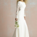Fabric is Crepe & Lace, silhouette is Sheath, neckline is High Neckline, sleeve style is Long Lace, train is Sweep Train, waistline is Natural, embellishment is Lace Appliqué, back is Low Scoop, color is Ivory/Nude, style is Minimalist Elegance, Buttons down the back