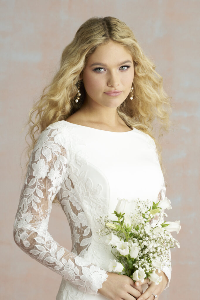 Fabric is Crepe & Lace, silhouette is Sheath, neckline is High Neckline, sleeve style is Long Lace, train is Sweep Train, waistline is Natural, embellishment is Lace Appliqué, back is Low Scoop, color is Ivory/Nude, style is Minimalist Elegance, Buttons down the back