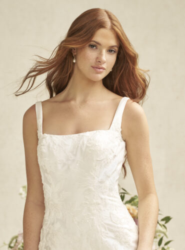 Fabric is Satin, silhouette is Fit and Flare, neckline is Square, sleeve style is Tank Straps, train is Chapel, waistline is Natural, embellishment is Beaded Lace Appliqué, back is Scoop with Buttons, color is Ivory, style is Modern Classic, Clean lines, elegant structure, subtle shimmer