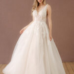 Fabric is Tulle & Lace, silhouette is A-Line, neckline is Deep V-Neck, sleeve style is Sleeveless, train is Chapel Train, waistline is Natural Waist, embellishment is Floral Appliqué, Beading, back is Deep V-Back, color is Soft Ivory, style is Romantic Elegance, Illusion Bodice, Sheer Detailing