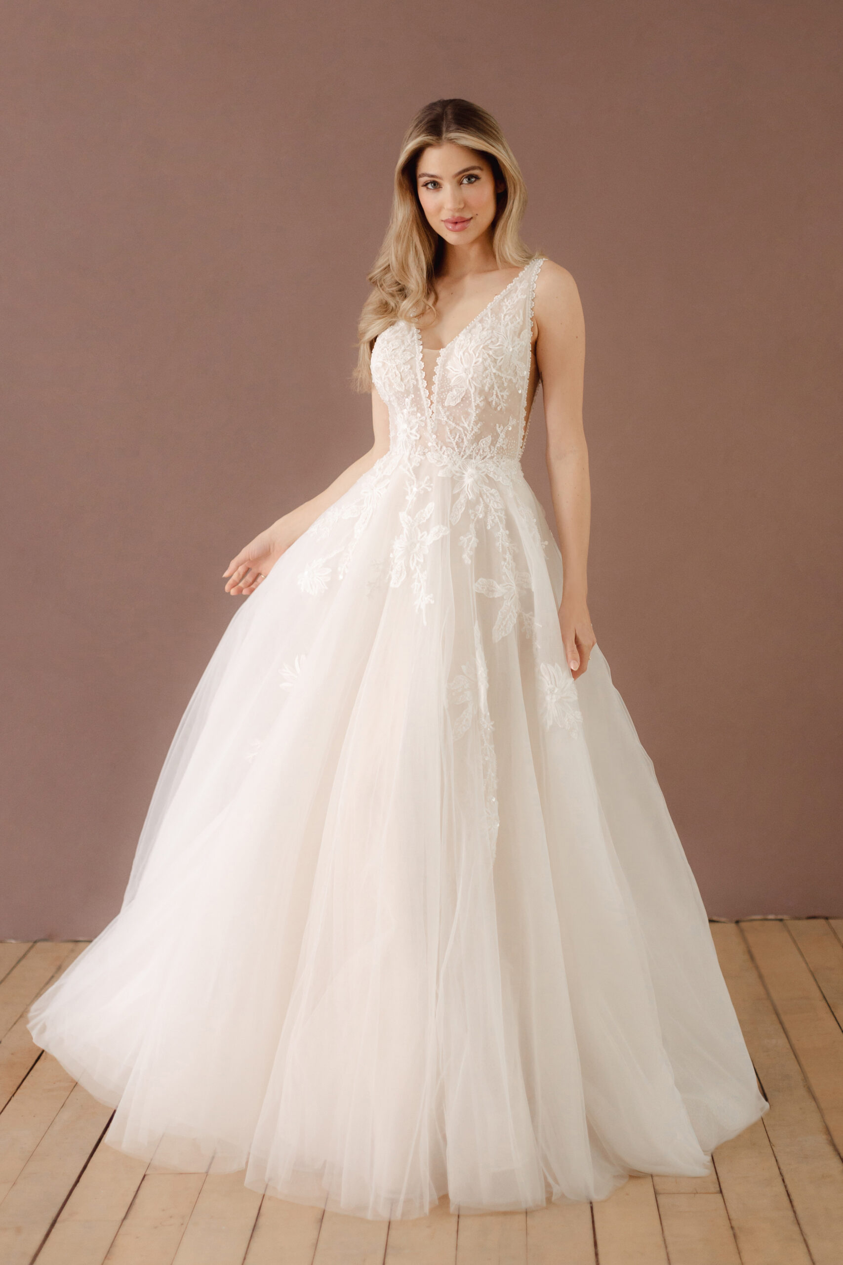 Fabric is Tulle & Lace, silhouette is A-Line, neckline is Deep V-Neck, sleeve style is Sleeveless, train is Chapel Train, waistline is Natural Waist, embellishment is Floral Appliqué, Beading, back is Deep V-Back, color is Soft Ivory, style is Romantic Elegance, Illusion Bodice, Sheer Detailing