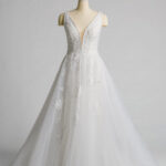 Fabric is Tulle & Lace, silhouette is A-Line, neckline is Deep V-Neck, sleeve style is Sleeveless, train is Chapel Train, waistline is Natural Waist, embellishment is Floral Appliqué, Beading, back is Deep V-Back, color is Soft Ivory, style is Romantic Elegance, Illusion Bodice, Sheer Detailing