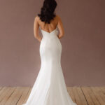 Fabric is Satin, silhouette is Fit and Flare / Modified A-Line, neckline is Halter, sleeve style is Sleeveless, train is Chapel Train, waistline is Natural Ruched, embellishment is 3D Floral Appliqué, back is Low V-Back, color is Ivory, style is Modern Minimalist Romance, Smooth satin with 3D floral details and a removable train for two distinct bridal looks.
