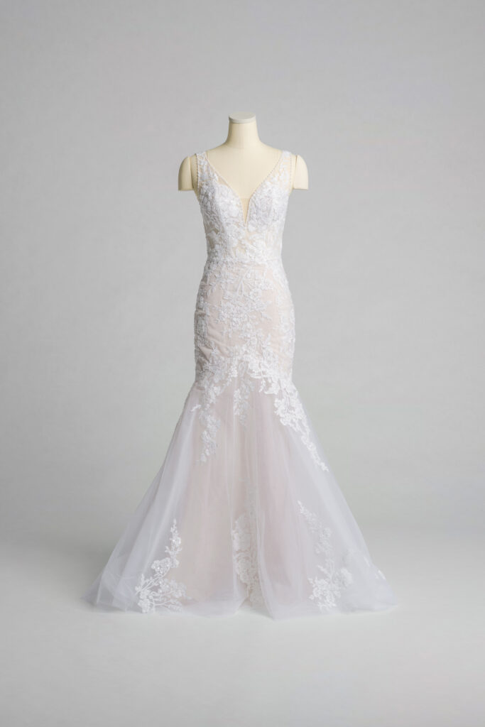 Fabric is Tulle & Lace, silhouette is Mermaid, neckline is Plunge V-neck, sleeve style is Sleeveless, train is Chapel, waistline is Natural, embellishment is Floral Lace Appliqué, back is Low Scoop, color is Ivory/Nude, style is Sexy Glam, Illusion bodice, fitted through hips, romantic floral detail