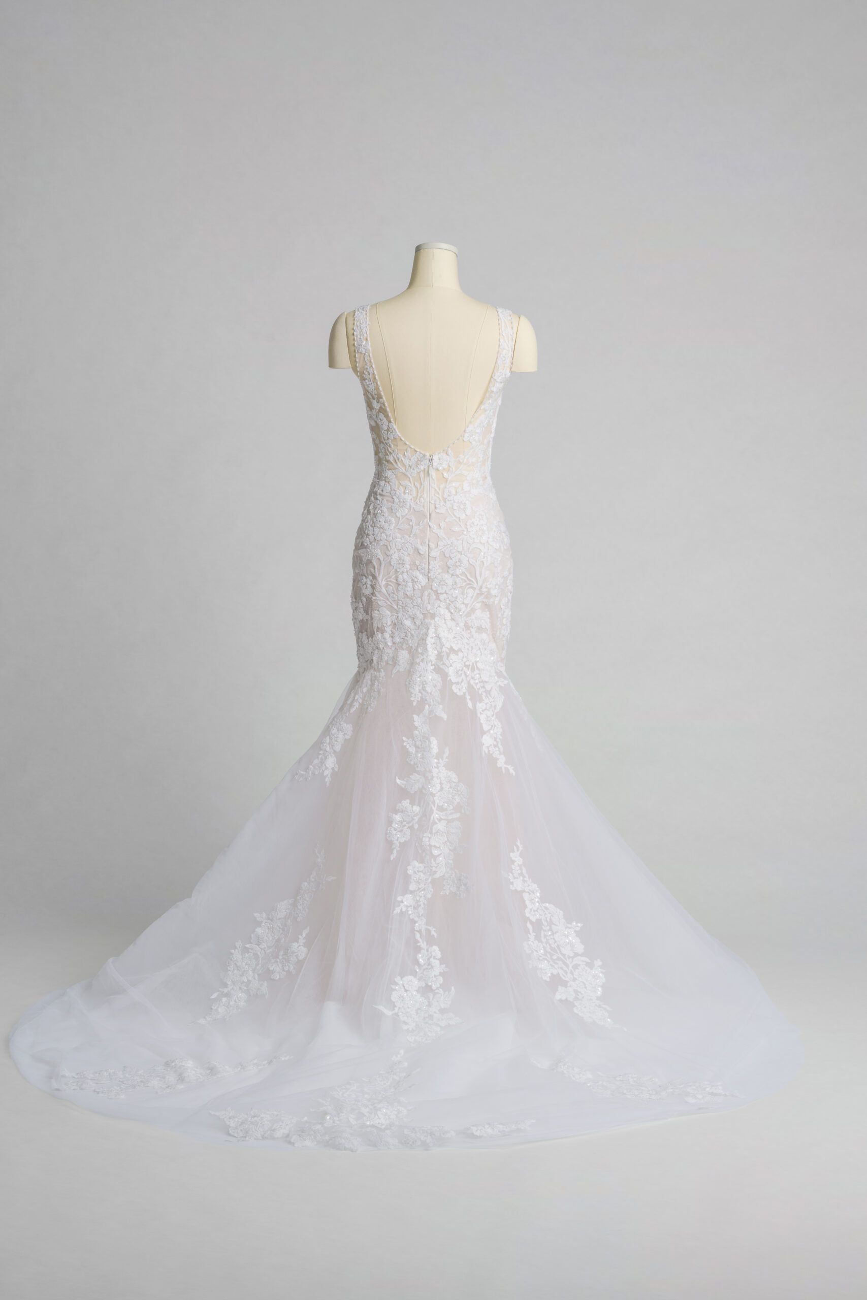 Fabric is Tulle & Lace, silhouette is Mermaid, neckline is Plunge V-neck, sleeve style is Sleeveless, train is Chapel, waistline is Natural, embellishment is Floral Lace Appliqué, back is Low Scoop, color is Ivory/Nude, style is Sexy Glam, Illusion bodice, fitted through hips, romantic floral detail