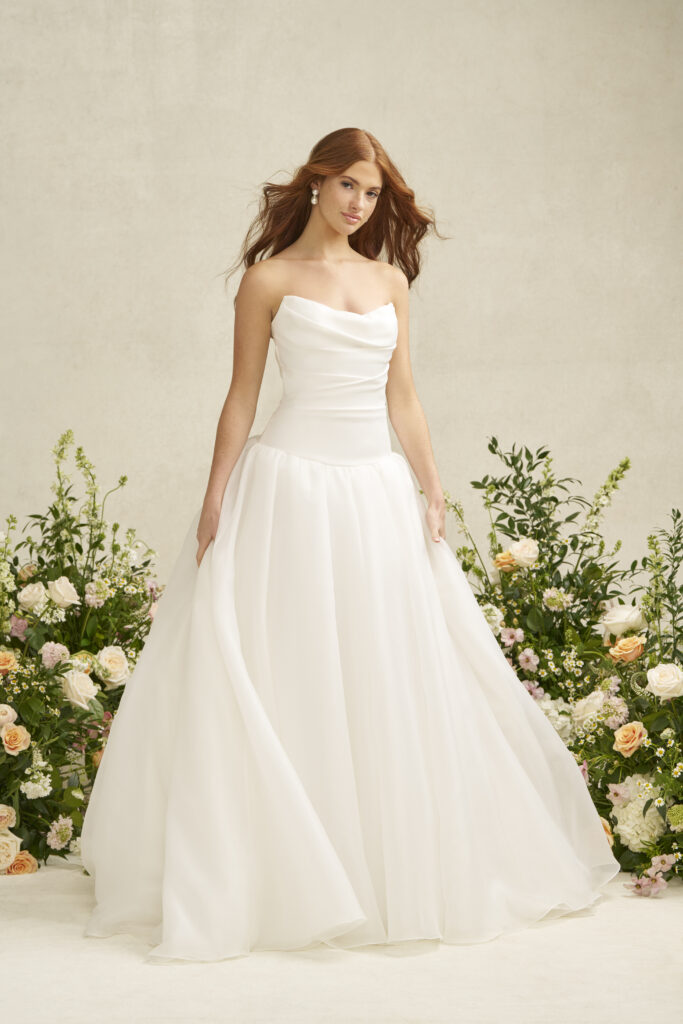 Fabric is Satin & Organza, silhouette is A-line, neckline is Scoop, sleeve style is Strapless, train is Chapel, waistline is Dropped, embellishment is Ruched Bodice, back is Covered Buttons, color is Ivory, style is Romantic Minimalism, Softly structured skirt