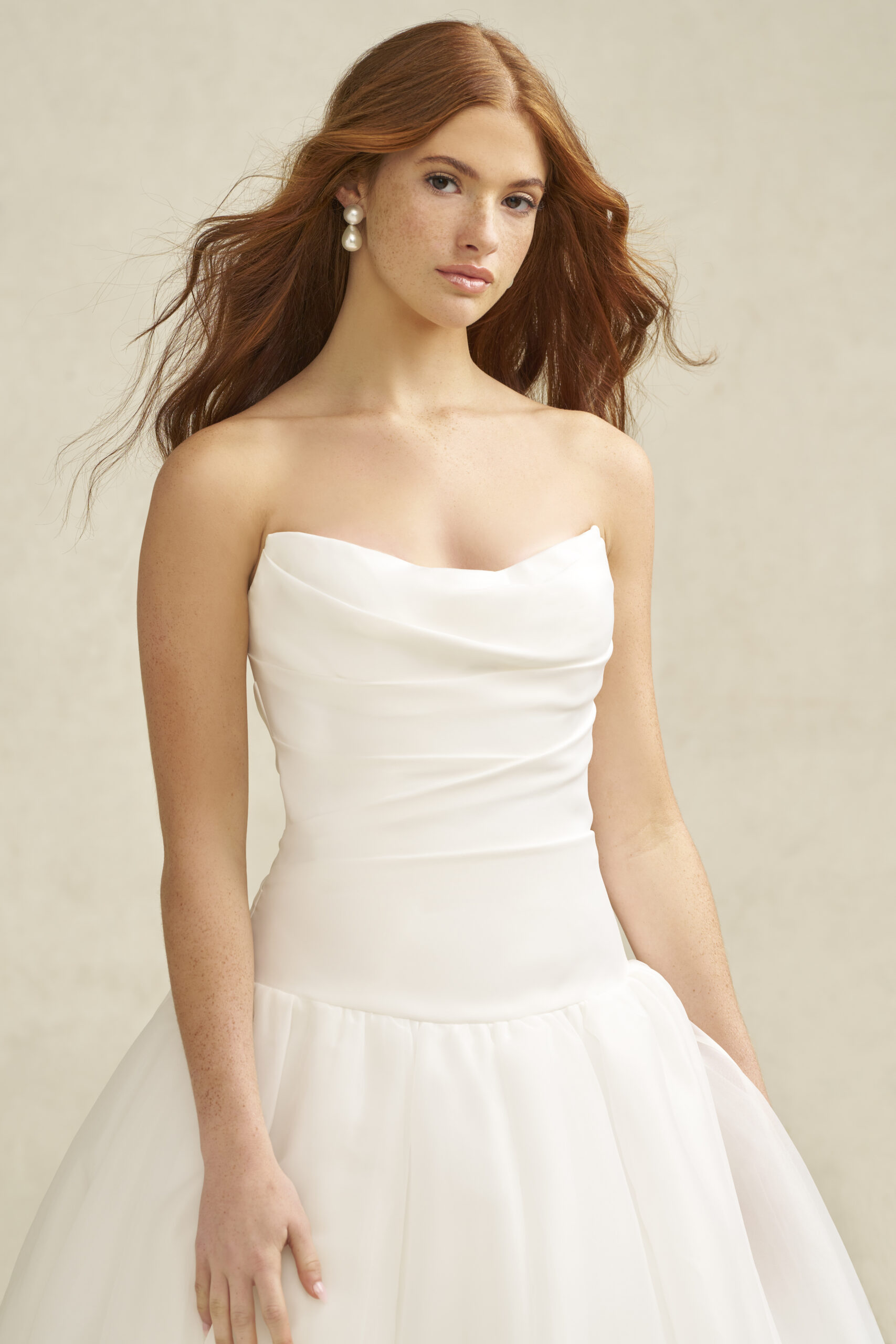 R3900 Studio 02 Fabric is Satin & Organza, silhouette is A-line, neckline is Scoop, sleeve style is Strapless, train is Chapel, waistline is Dropped, embellishment is Ruched Bodice, back is Covered Buttons, color is Ivory, style is Romantic Minimalism, Softly structured skirt