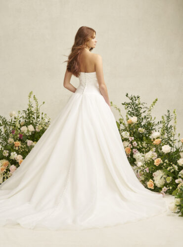 Fabric is Satin & Organza, silhouette is A-line, neckline is Scoop, sleeve style is Strapless, train is Chapel, waistline is Dropped, embellishment is Ruched Bodice, back is Covered Buttons, color is Ivory, style is Romantic Minimalism, Softly structured skirt