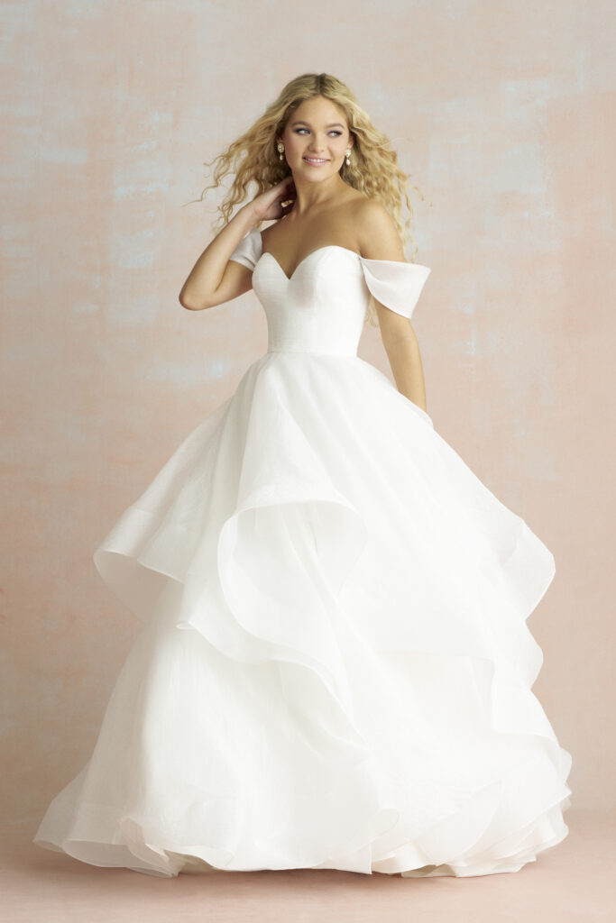 Fabric is Crushed organza, silhouette is Ballgown, neckline is Sweetheart, sleeve style is Off-shoulder, train is Chapel, waistline is Natural, embellishment is Layered skirt, back is V-back, color is Ivory, style is Romantic classic, Handkerchief hem